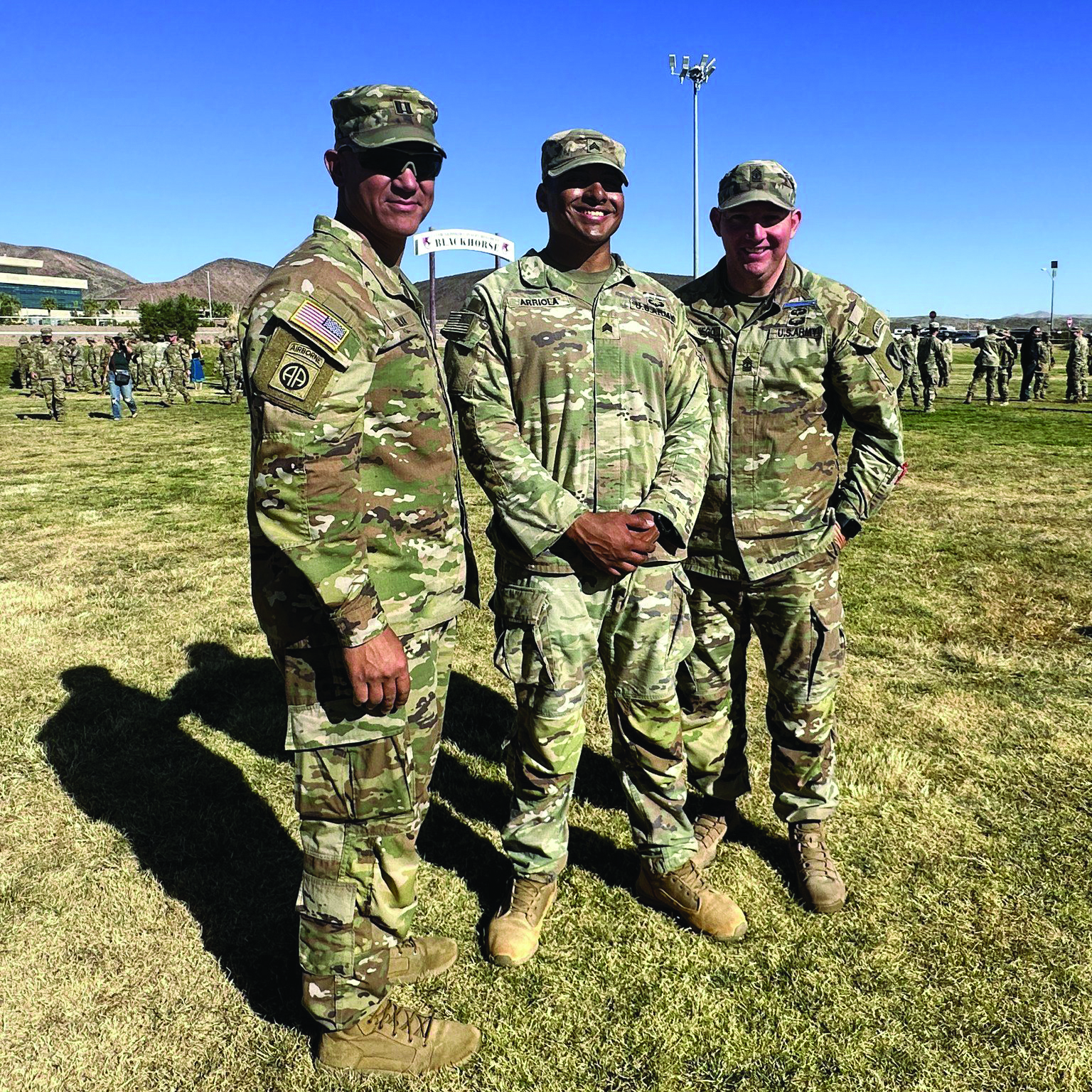 SGT Steven Arriola (center), a paralegal with HHC, U.S. Army Garrison, Fort Irwin, CA, poses with his company commander (left) and first sergeant (right) after earning the prestigious Expert Soldier Badge on 20 October 2023. (Credit: SSG Elizabeth Bryson)